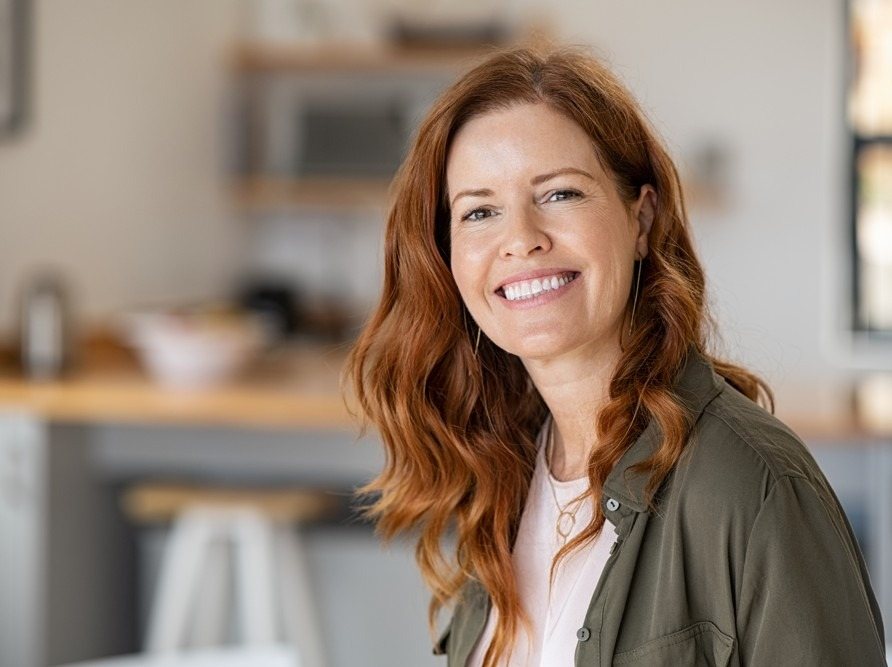 Smiling woman in her 40s at home